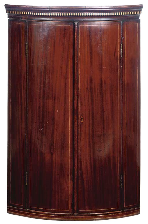 A LATE GEORGE III MAHOGANY AND LINE INLAID BOWFRONT HANGING CORNER CUPBOARD