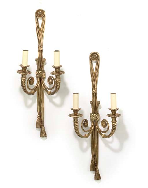A SET OF FOUR GILT-METAL TWIN-LIGHT WALL APPLIQUES