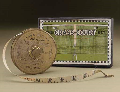 A BRASS LAWN TENNIS TAPE MEASURE