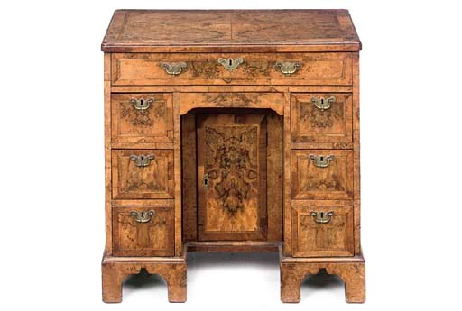 A GEORGE II WALNUT AND FEATHERBANDED KNEEHOLE DESK