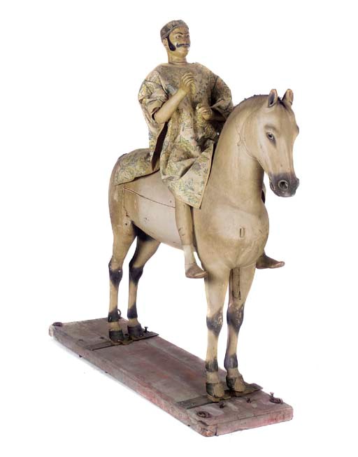 A CARVED AND PAINTED MODEL OF A MOGHUL ON HORSEBACK