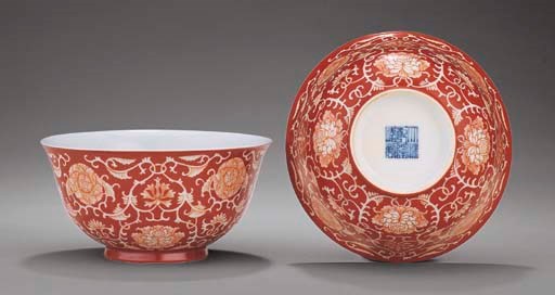 A PAIR OF REVERSE-DECORATED CORAL-GROUND BOWLS