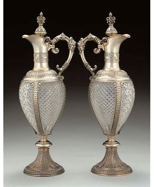 A PAIR OF LATE 19TH CENTURY GERMAN PARCEL-GILT MOUNTED CUT-GLASS CLARET JUGS,