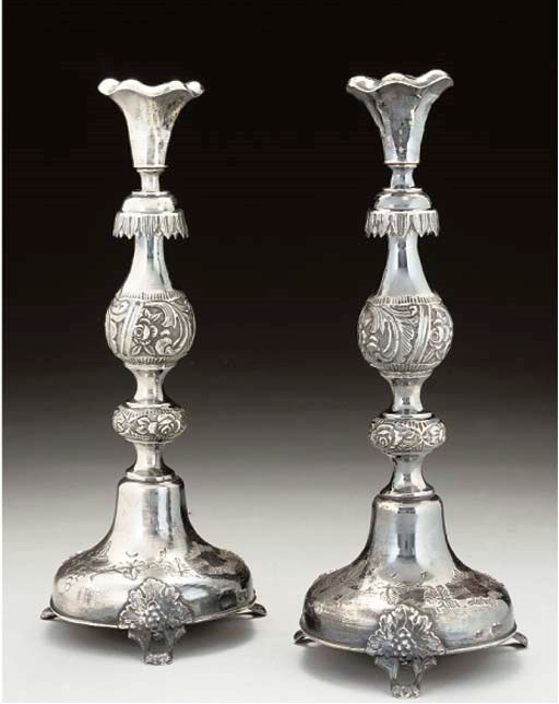 JUDAICA:- A PAIR OF LATE 19TH CENTURY POLISH SABBATH CANDLESTICKS,