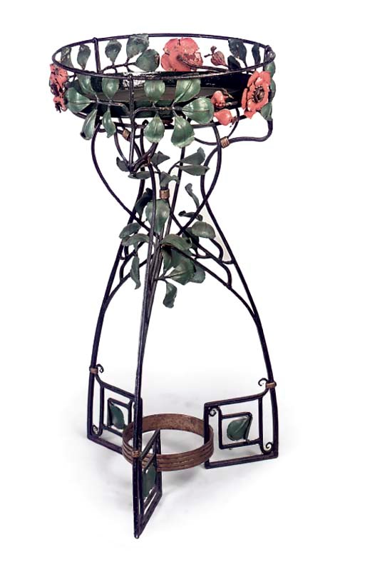 A WROUGHT IRON AND POLYCHROME DECORATED JARDINIERE STAND