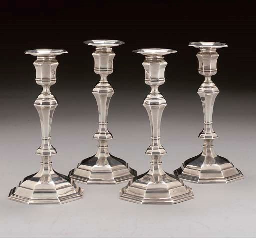 FOUR GEORGE II STYLE CANDLESTICKS (FILLED)