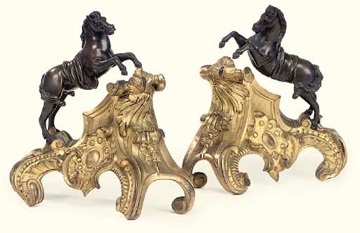 A PAIR OF EARLY LOUIS XV BRONZE AND ORMOLU CHENETS
