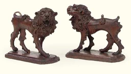 A PAIR OF ITALIAN WALNUT CONTRAPOSTO MODELS OF LIONS