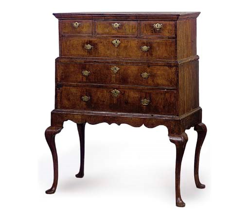 A WALNUT CROSS AND FEATHER BANDED CHEST ON STAND