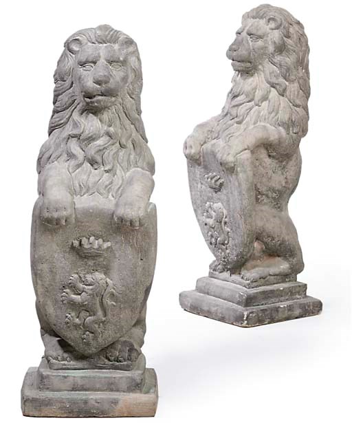 A PAIR OF COMPOSITION STONE HERALDIC LIONS