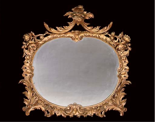A CARVED GILTWOOD AND GESSO OVAL WALL MIRROR