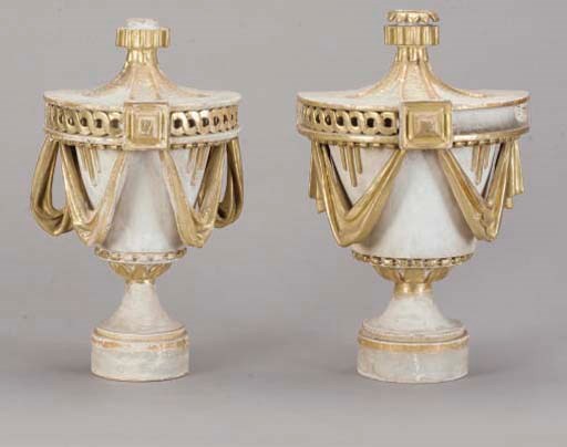 A PAIR OF ITALIAN WHITE-PAINTED AND PARCEL-GILT DECORATED URN FORM FINIALS,