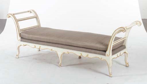 A LOUIS XV STYLE CREAM-PAINTED AND PARCEL-GILT DECORATED DAY BED,