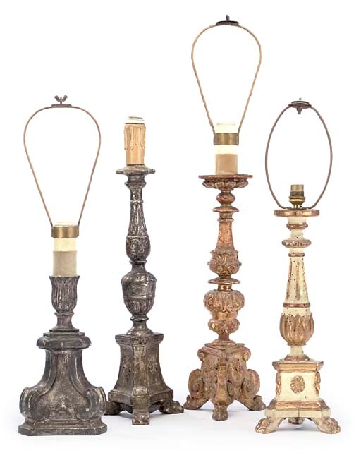 A COLLECTION OF FOUR VARIOUS SILVERED, PAINTED AND GILTWOOD TABLE ALTAR LAMPS