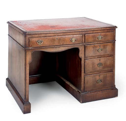 A WALNUT KNEEHOLE DESK