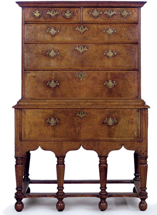 A WALNUT FEATHERBANDED CHEST ON STAND