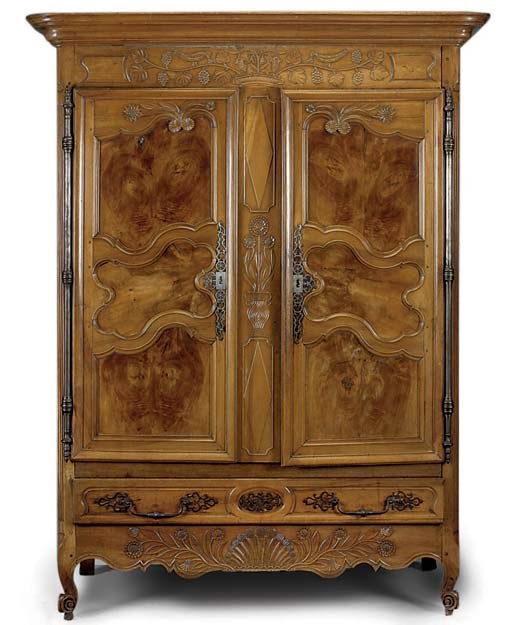 A FRENCH PROVINCIAL CARVED WALNUT ARMOIRE