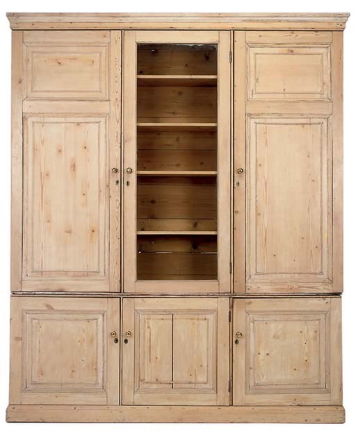 A PINE BOOKCASE/CUPBOARD