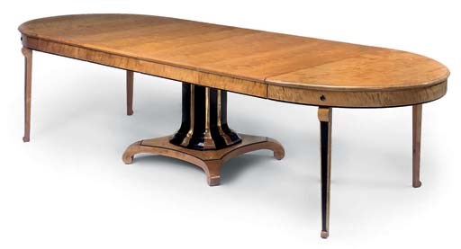 A BIRCH EBONISED AND PARCEL GILT EXTENDING DINING TABLE