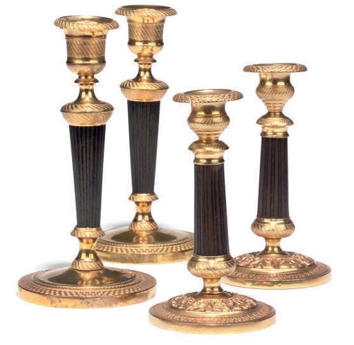A PAIR OF FRENCH GILT AND PATINATED BRASS CANDLESTICKS