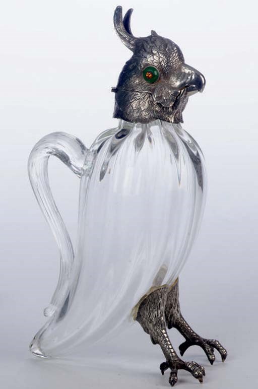 A PAIR OF SILVER-MOUNTED PARROT-FORM CLEAR GLASS DECANTERS,
