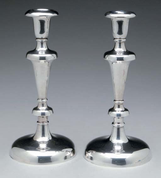 A PAIR OF CONTINENTAL SILVER-PLATED CANDLESTICKS,