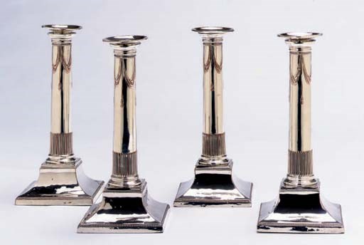 A SET OF FOUR SILVER-PLATED CANDLESTICKS,