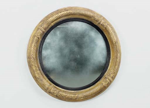 A LATE REGENCY CARVED GILT GESSO CONVEX MIRROR,