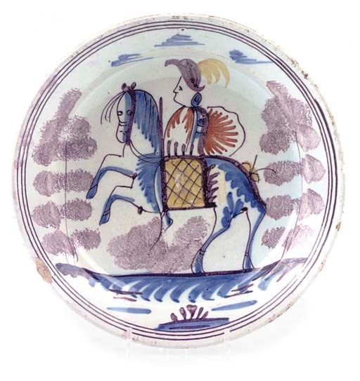 A FRISIAN DELFT EQUESTRIAN DEEP PLATE AND AN ENGLISH DELFT PLATE