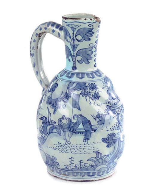 A DUTCH DELFT BLUE AND WHITE SPIRALLY MOULDED OVIFORM JUG