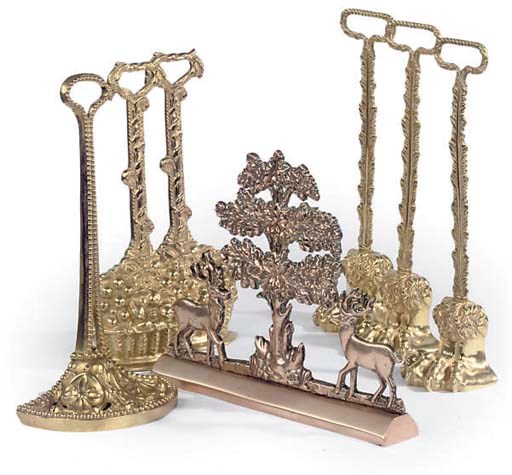 A COLLECTION OF SEVEN GILT BRASS DOOR PORTERS