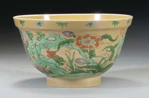 A Chinese famille verte bowl on cafe-au-lait ground, Kangxi