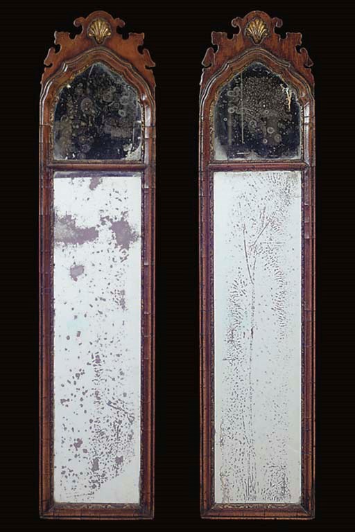 A PAIR OF WALNUT AND PARCEL GILT MIRRORS