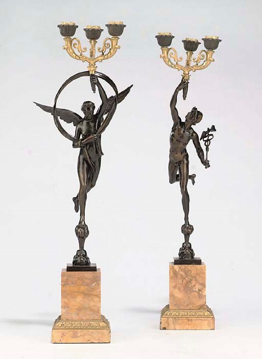 A PAIR OF FRENCH BRONZE AND PARCEL GILT THREE-LIGHT FIGURAL CANDELABRA