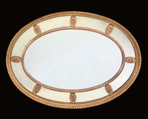 A GILTWOOD OVAL MIRROR