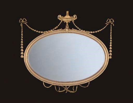 AN EDWARDIAN GILTWOOD AND COMPOSITION MIRROR