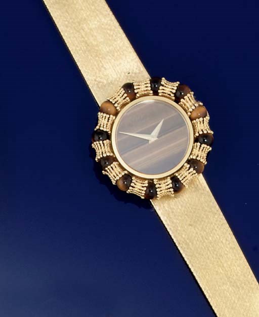 AN 18CT. GOLD AND TIGER'S EYE WRISTWATCH, BY CHOPARD FOR KUTCHINSKY