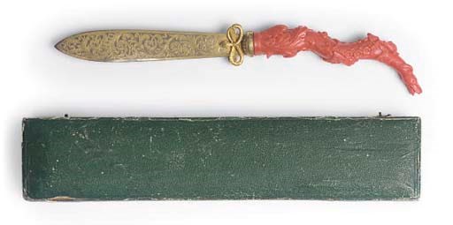 A CORAL HANDLED GILT-METAL PAPER KNIFE