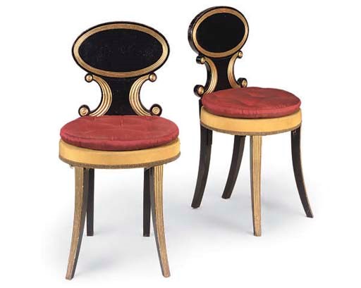 A PAIR OF REGENCY BLACK PAINTED AND PARCEL GILT HALL CHAIRS