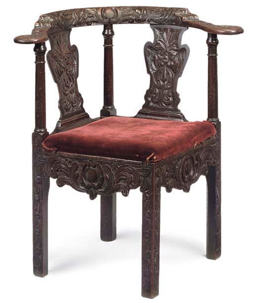 A CARVED OAK CORNER ARMCHAIR