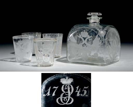 An Engraved Colorless Glass Decanter and Four Tumblers