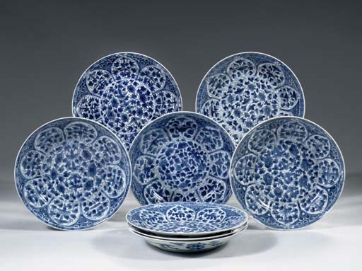A set of eight blue and white plates