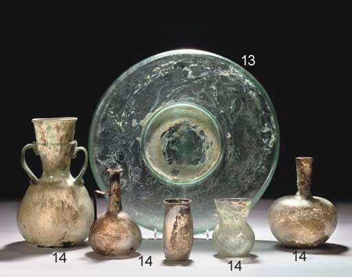 A LARGE ROMAN GREEN GLASS DISH