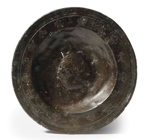 A PEWTER PUNCH-DECORATED SAUCER
