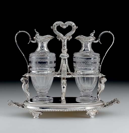 A GEORGE III SILVER AND GLASS CRUET STAND