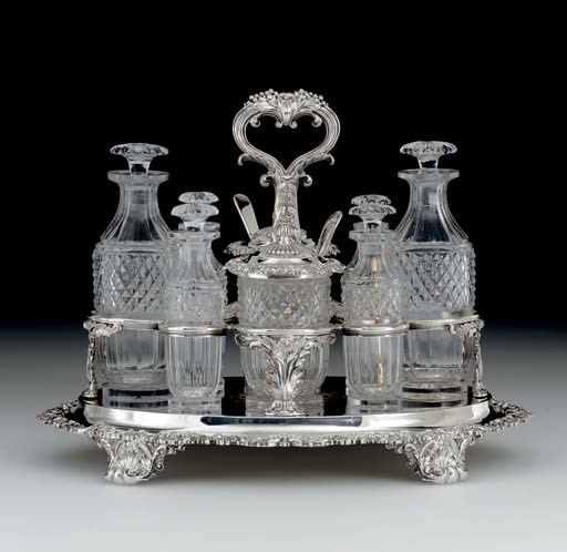 A GEORGE IV SILVER AND GLASS CRUET STAND