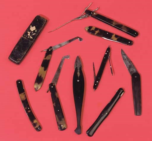 A collection of seven scalpels with tortoiseshell guards,