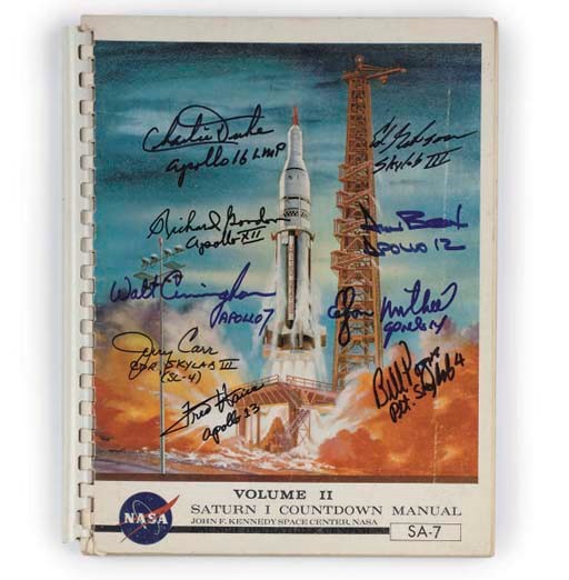 an apollo saturn 1 rocket countdown manual autographed by several apollo pilots,