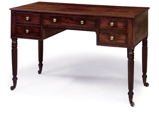 A GEORGE IV MAHOGANY AND PARCEL-EBONISED WRITING TABLE
