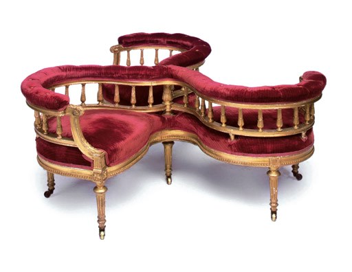 A LATE VICTORIAN GILTWOOD CONVERSATION SETTEE